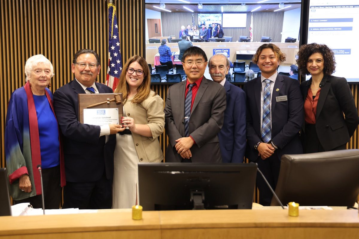 Rebecca Barrett and district leaders present a commendation at the Governing Board dais